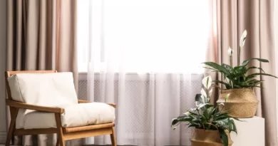 image in a blog how to select curtains, featuring beige curtains and wooden accent chair