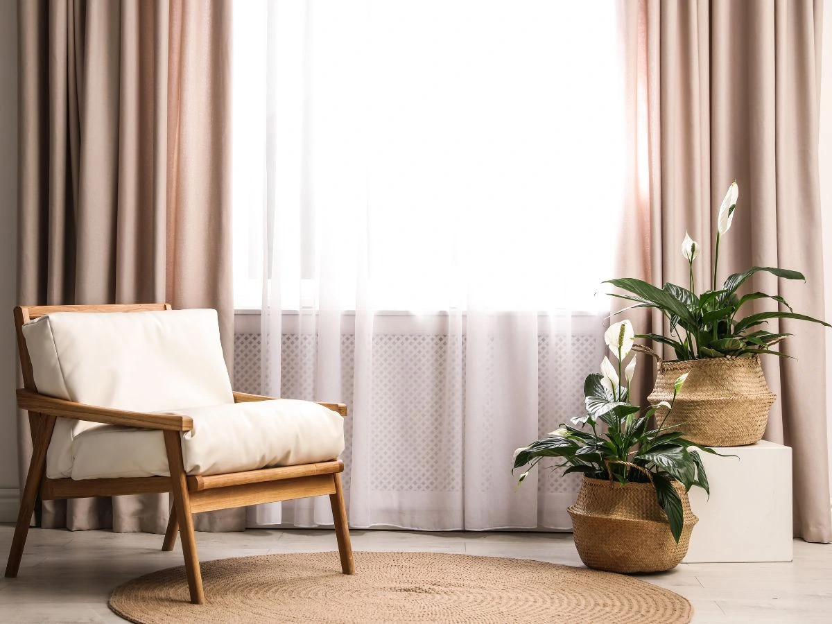 image in a blog how to select curtains, featuring beige curtains and wooden accent chair