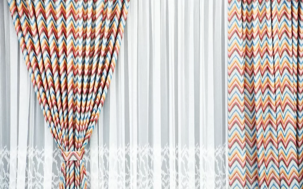 image to showcase importance of this blog on 'how to choose curtains'. Image is of Chaotic and overwhelming printed curtains, demonstrating the need to balance patterns and colors for a more harmonious look and so 