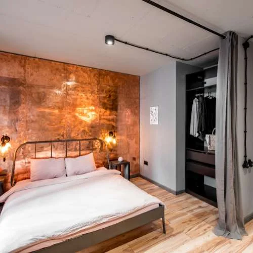 bedroom with Industrial character with exposed electrical pipes on ceiling