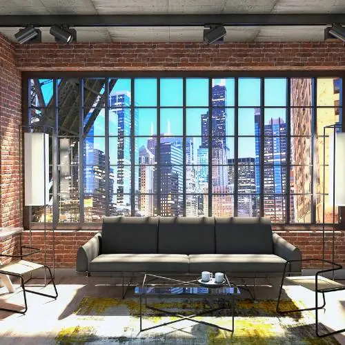 A living room featuring an exposed brick wall and a large window with a sleek metal frame.