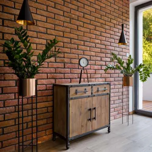 Exposed brick wall and wooden unit in the foyer area 