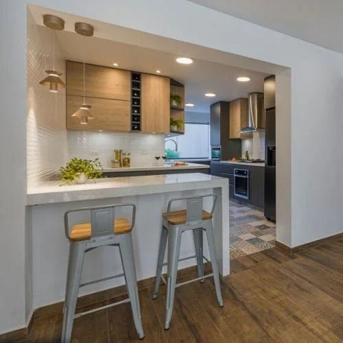 A well-lit kitchen with decorative lamps adding a warm ambiance to the room's decor.