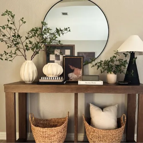 entryway console table decorated with accessories in layers