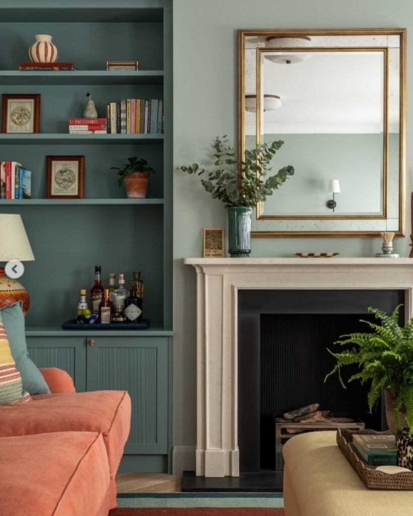 Cozy living room, decorated in vibrant colours. Mirror is added on the wall above fireplace to Reflect Light and Space