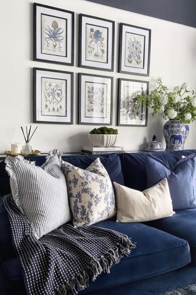 Navy sofa with botanical pillows and blue-and-white accessories