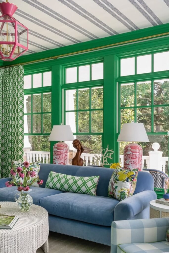 Bright room with green trim and blue sofa, styled with patterned cushions