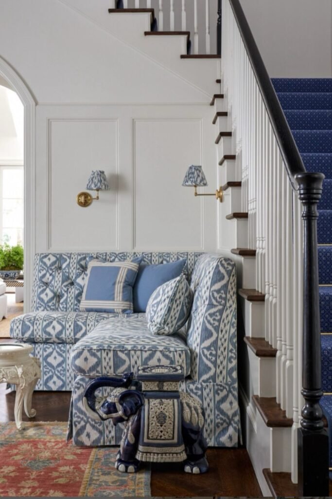 Ikat print blue sofa in stairway nook with coordinated lighting