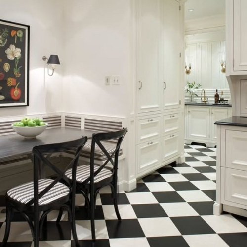 Modern kitchen with black and white checkered floor and white kitchen cabinets