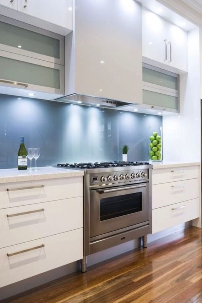 Glossy glass- kitchen backsplash ideas reflecting light, creating a bright and airy ambiance