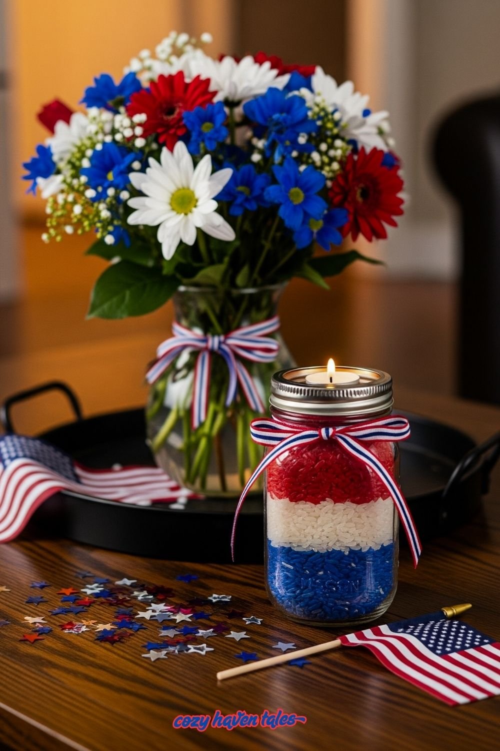 4th of july decor: table decorated with Red, white, and blue dyed rice layered in a mason jar with a tealight candle. and flower pot.