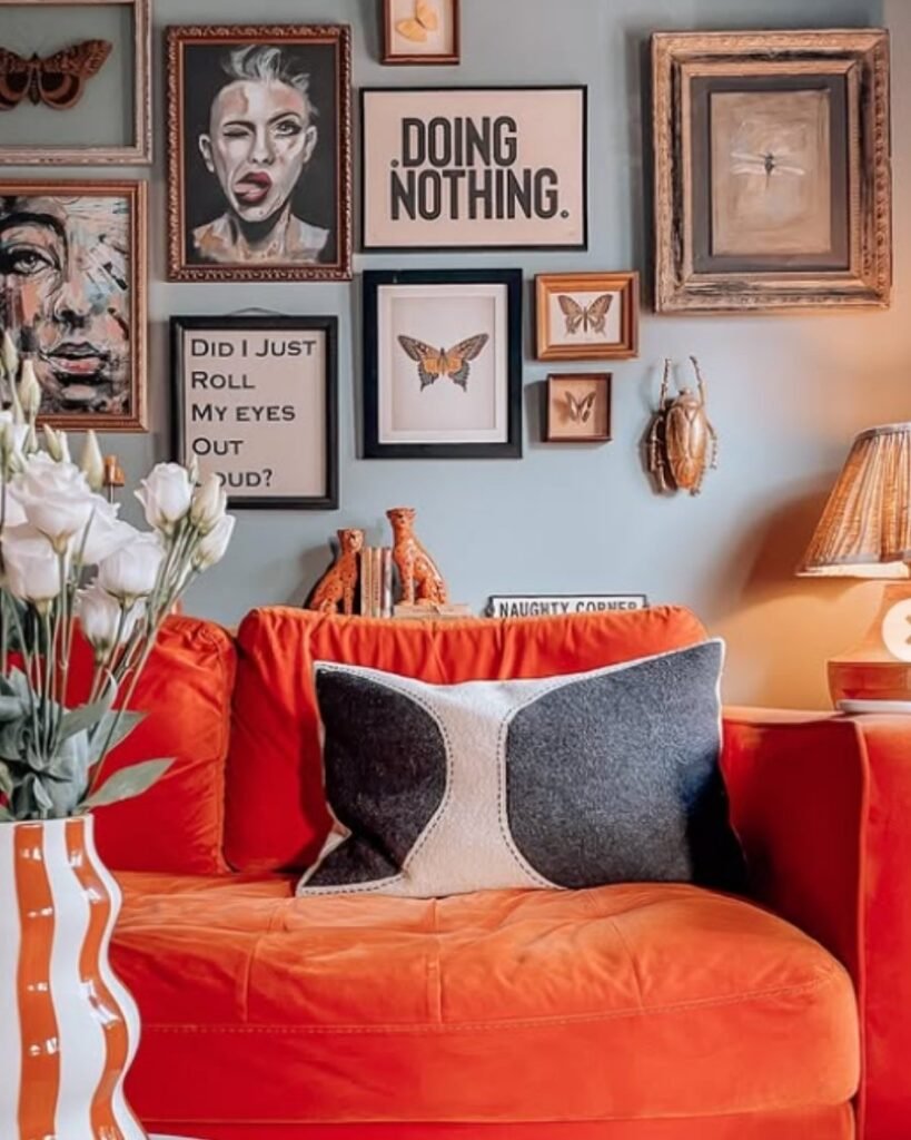 Coral sofa set against a gallery wall with bold decor accents —perfect as a unique sofa colour for artistic homes