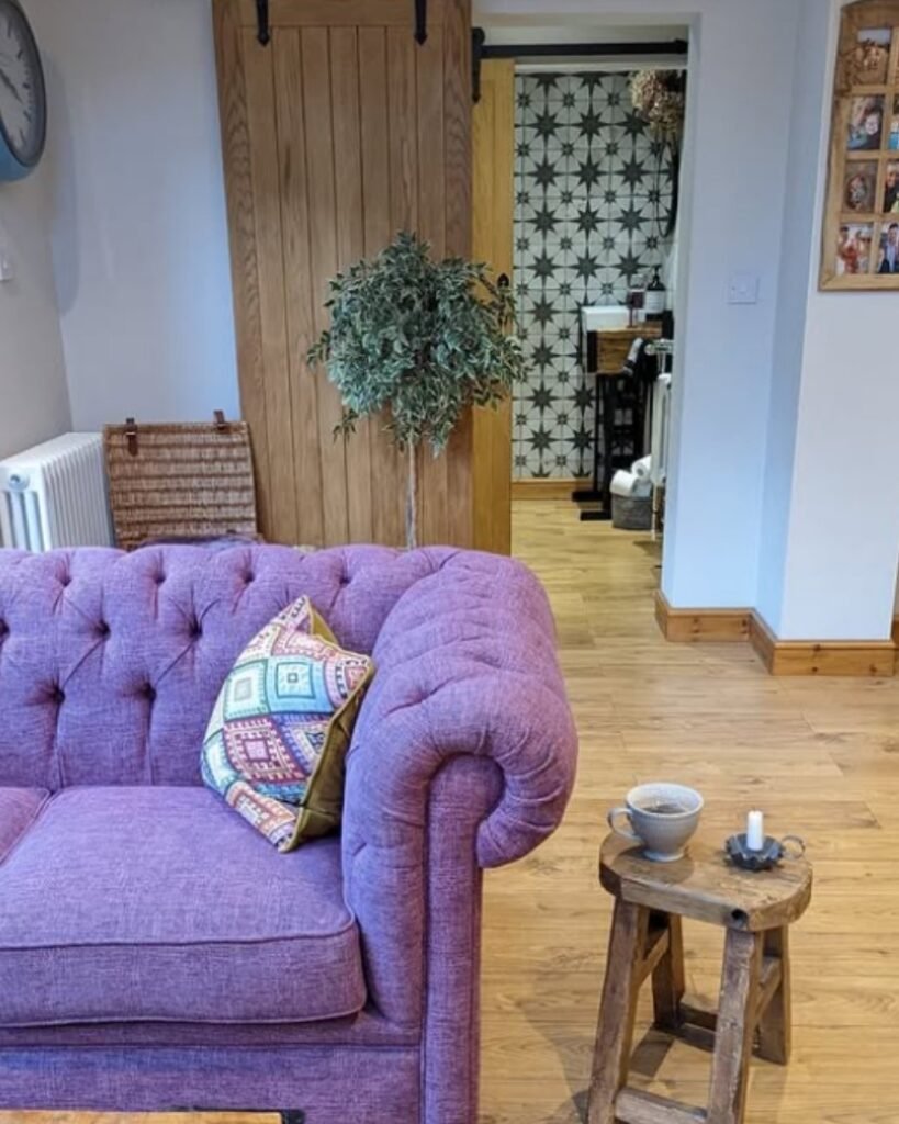 Lavender tufted velvet sofa with an abstract cushion in a cozy living space
