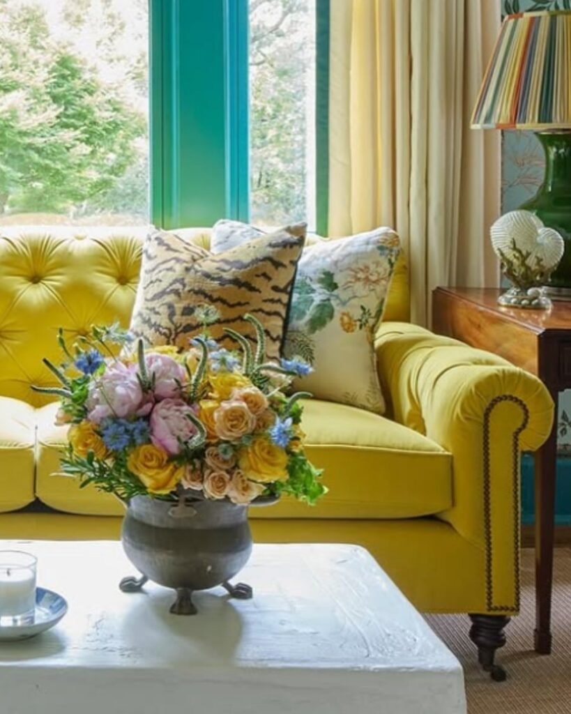 Lemon yellow sofa with floral cushions and bright decor