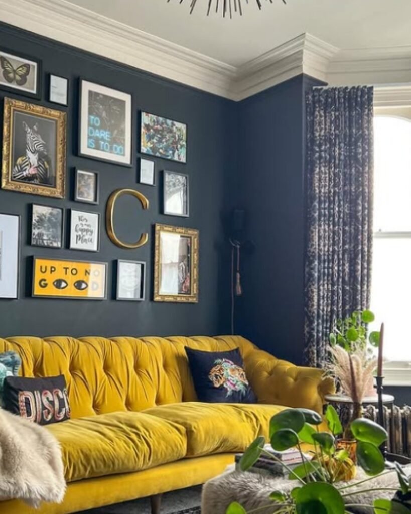 Mustard yellow velvet sofa set against a gray gallery wall