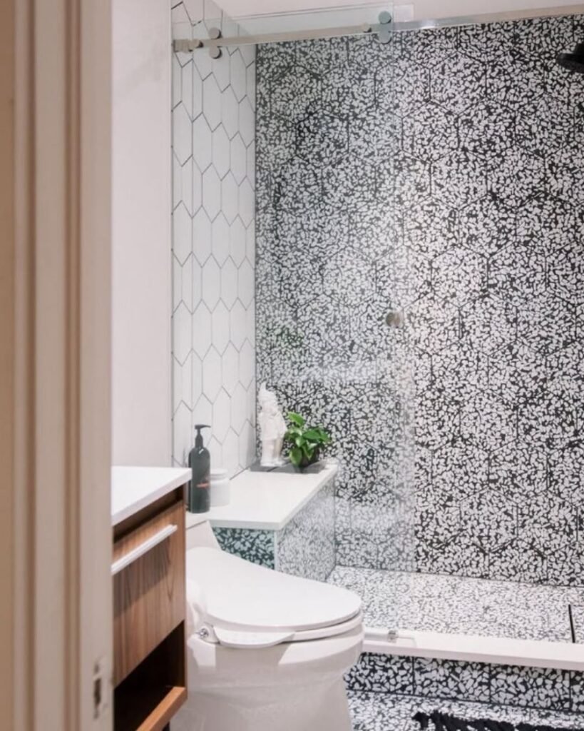 modern design with black‑and‑white terrazzo tile and wood vanity