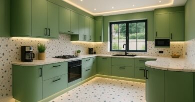 Modern sage green kitchen with terrazzo tile backsplash, quartz countertop, and LED strip lighting under cabinets.