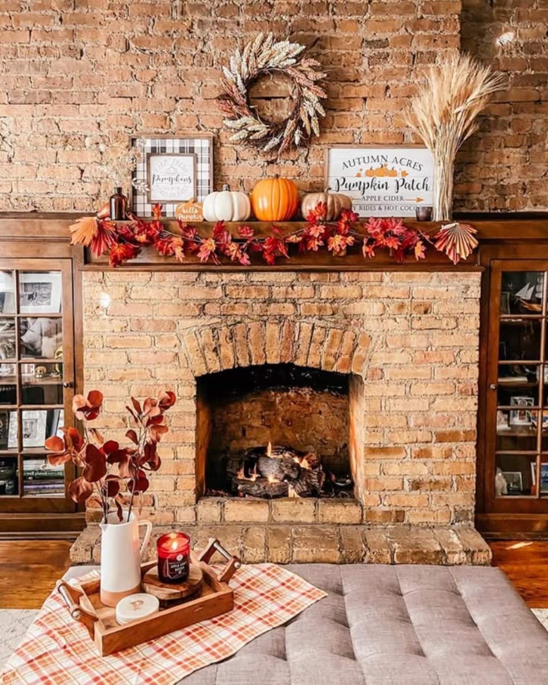 Rustic fall mantel decorating ideas with exposed brick, pumpkins, plaid touches, and soft farmhouse details.