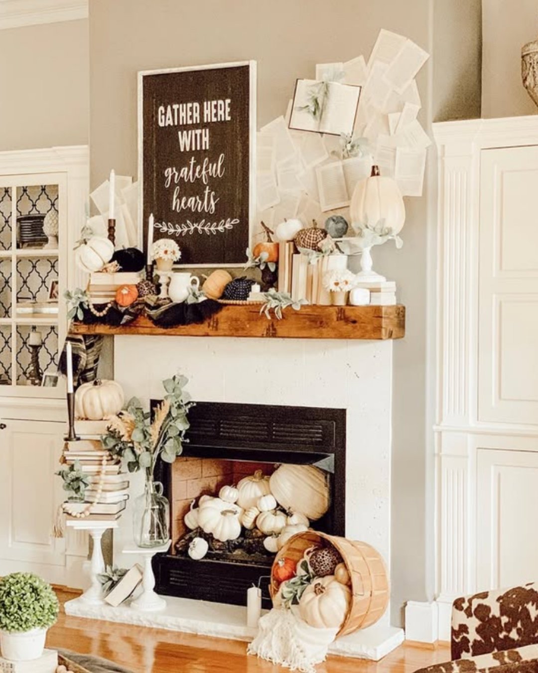 Playful fall mantel decorating ideas with a layered look, quote board, soft white pumpkins, books, and cozy neutral accents.