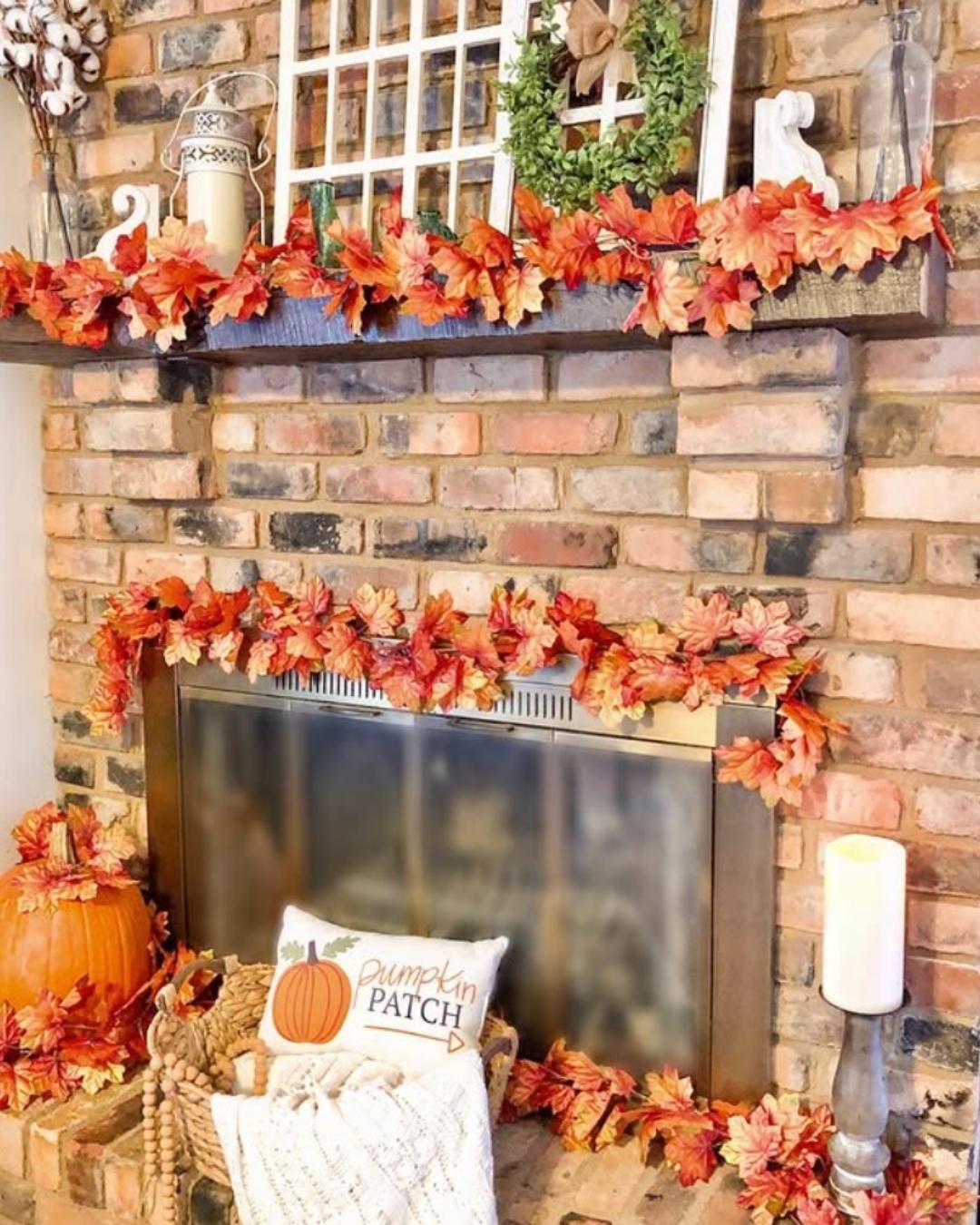 Fall mantel decorating ideas with exposed brick, orange leaf garlands, and farmhouse accessories.