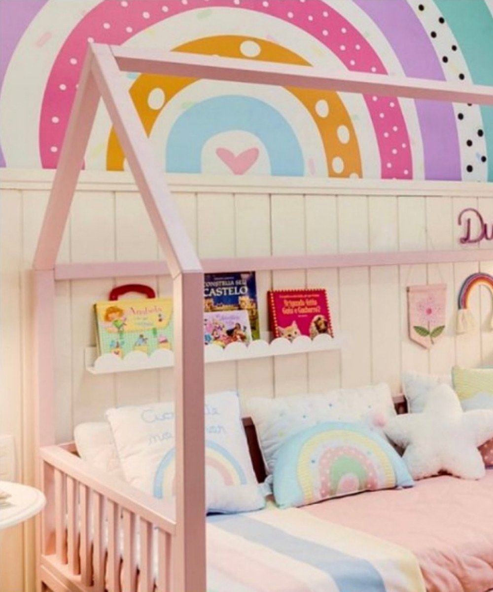 Montessori pastel bedroom with rainbow mural and soft pillows
