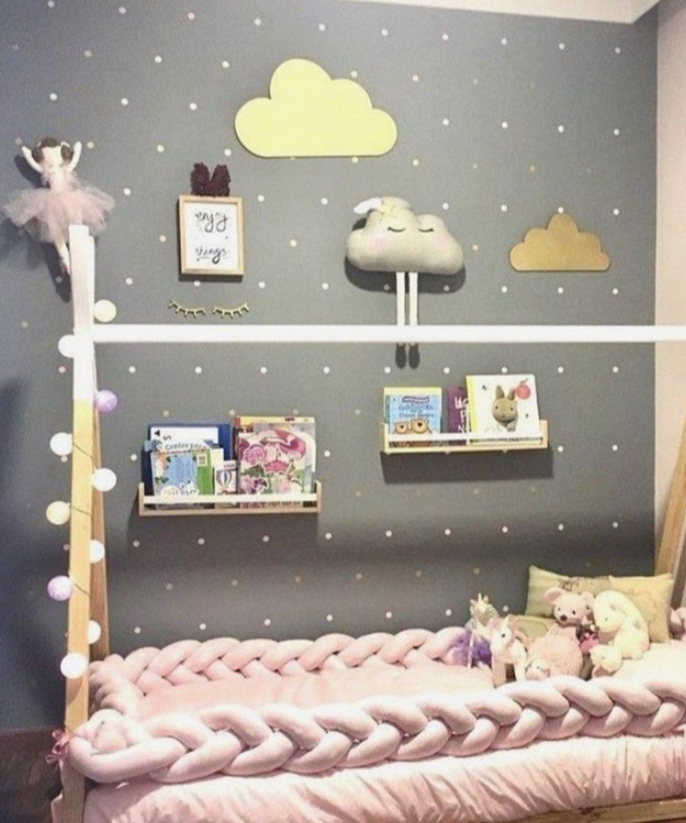 Montessori toddler bed with cloud decor and fairy lights