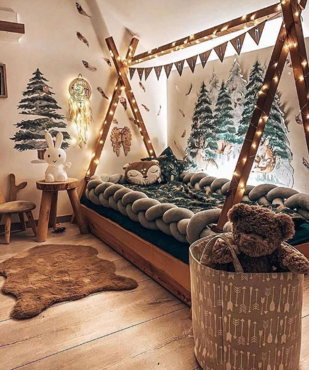 Montessori forest-themed bedroom with fairy lights and animal pillows