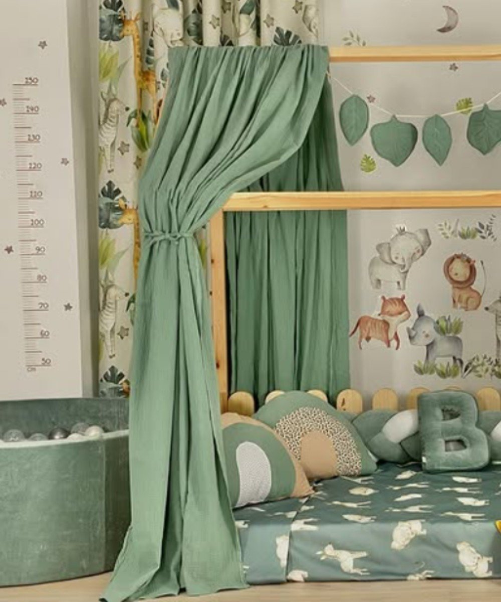 Jungle-themed Montessori bedroom with green curtains and animal decor