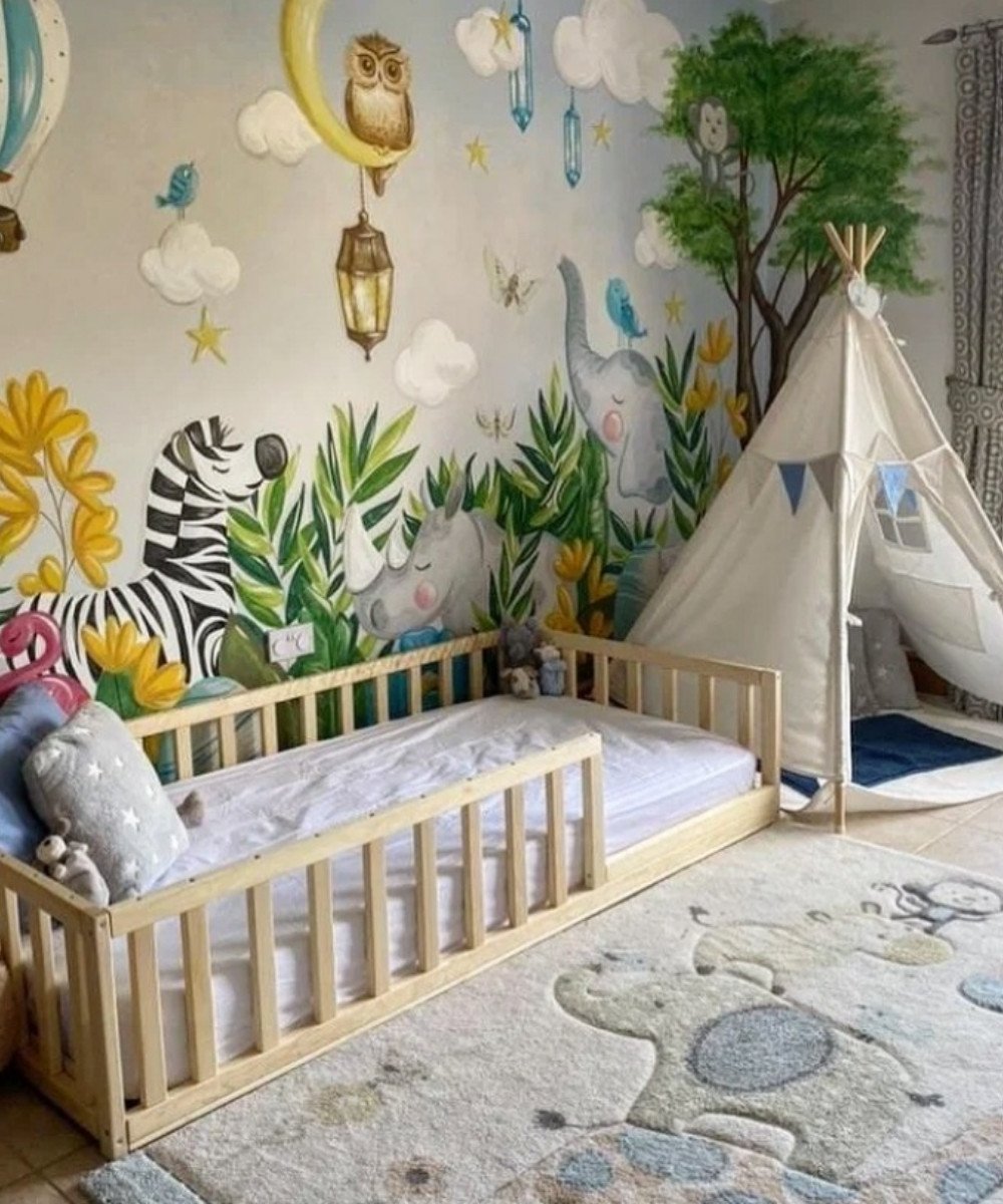 Montessori jungle-themed room with safari mural and teepee tent