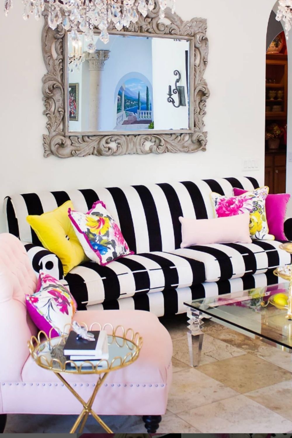 Glam living room with black and white striped sofa and colorful cushions
