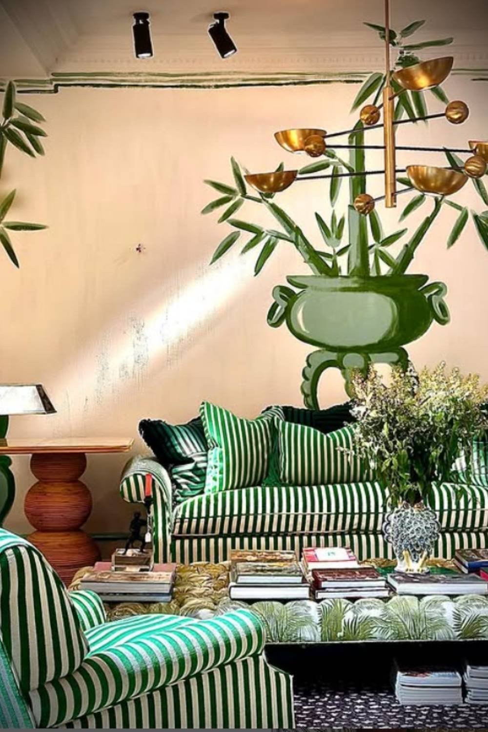 Green striped sofa set in an artistic room with hand-painted wall mural
