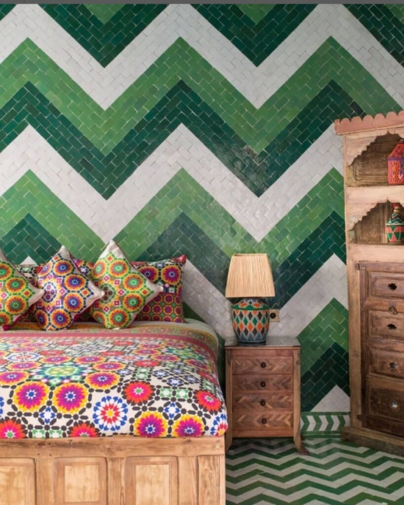 Colorful Moroccan boho bedroom with green tile wall, mosaic bedding, and wooden accents