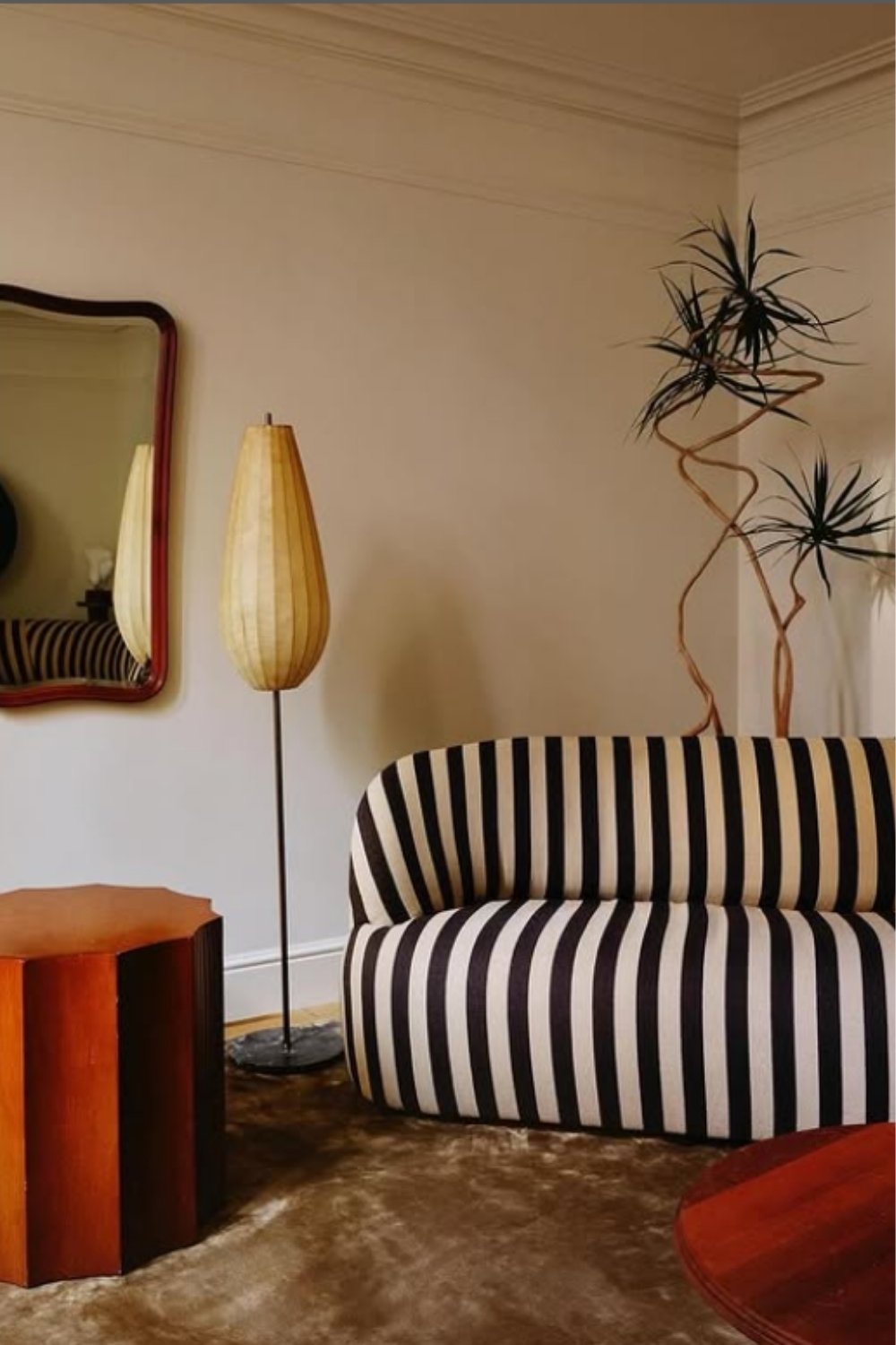 Modern striped sofa with curved edges and minimal midcentury decor