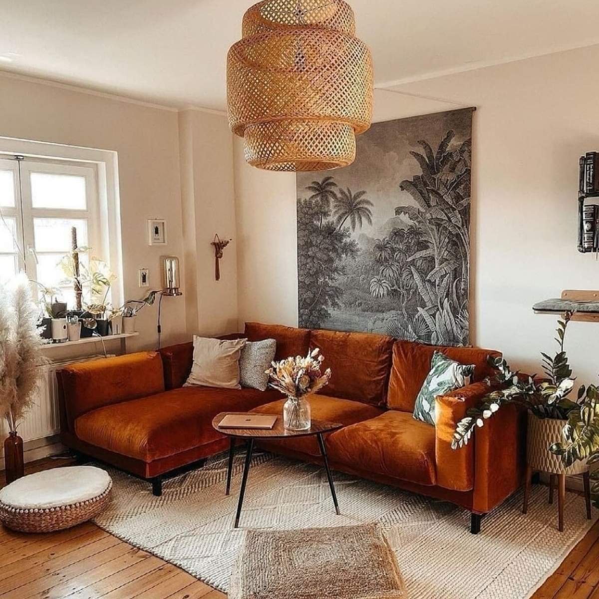 Bohemian tan sectional sofa with rattan pendant and tropical mural