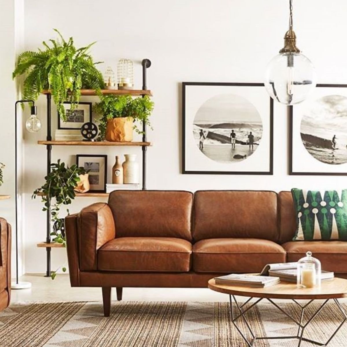 Mid-century tan sofa with indoor plants and black-and-white wall art