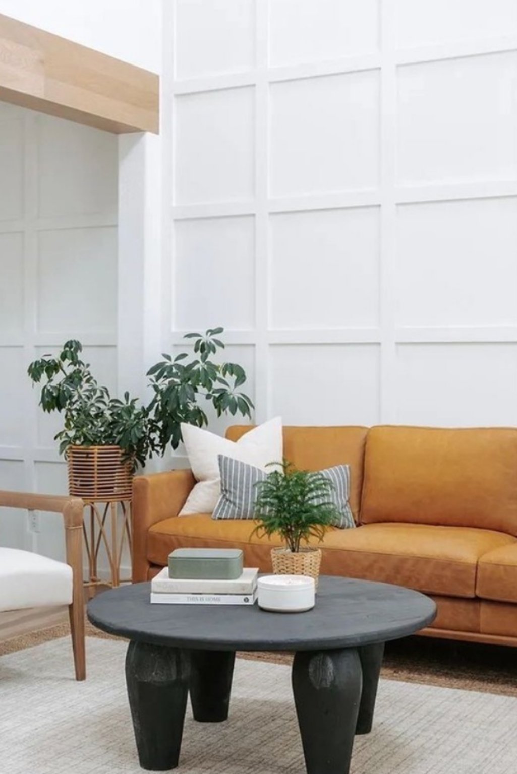Clean modern space with paneled white walls and mustard-tan sofa
