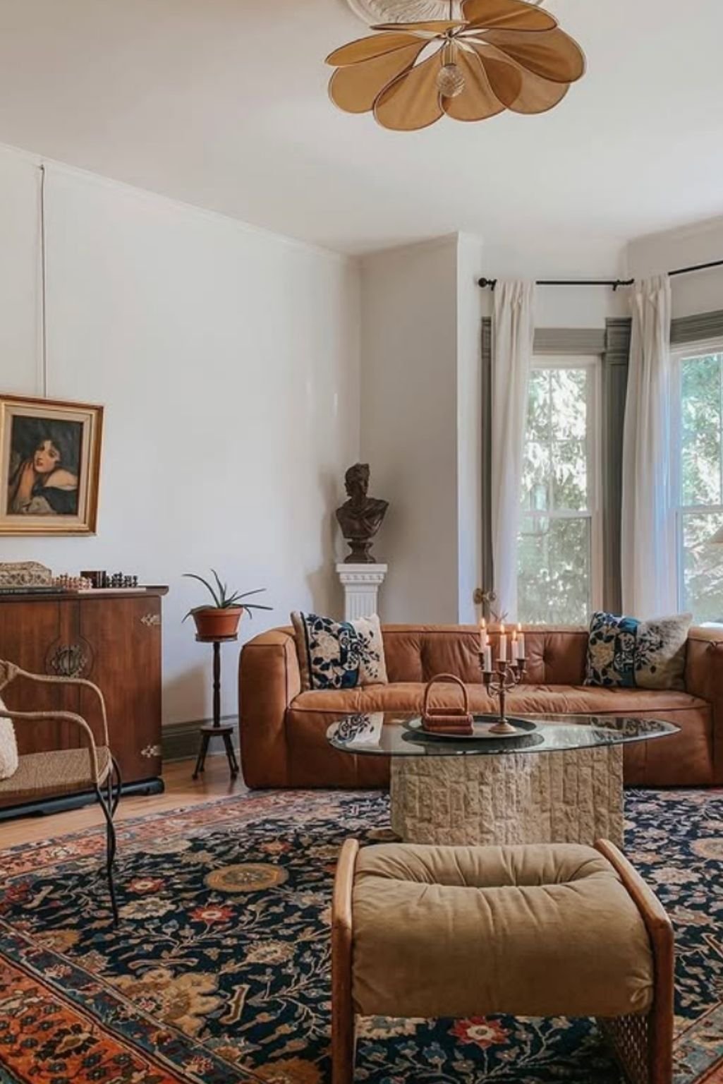 Eclectic tan sofa living room idea with vintage rug and mix-matched wall art