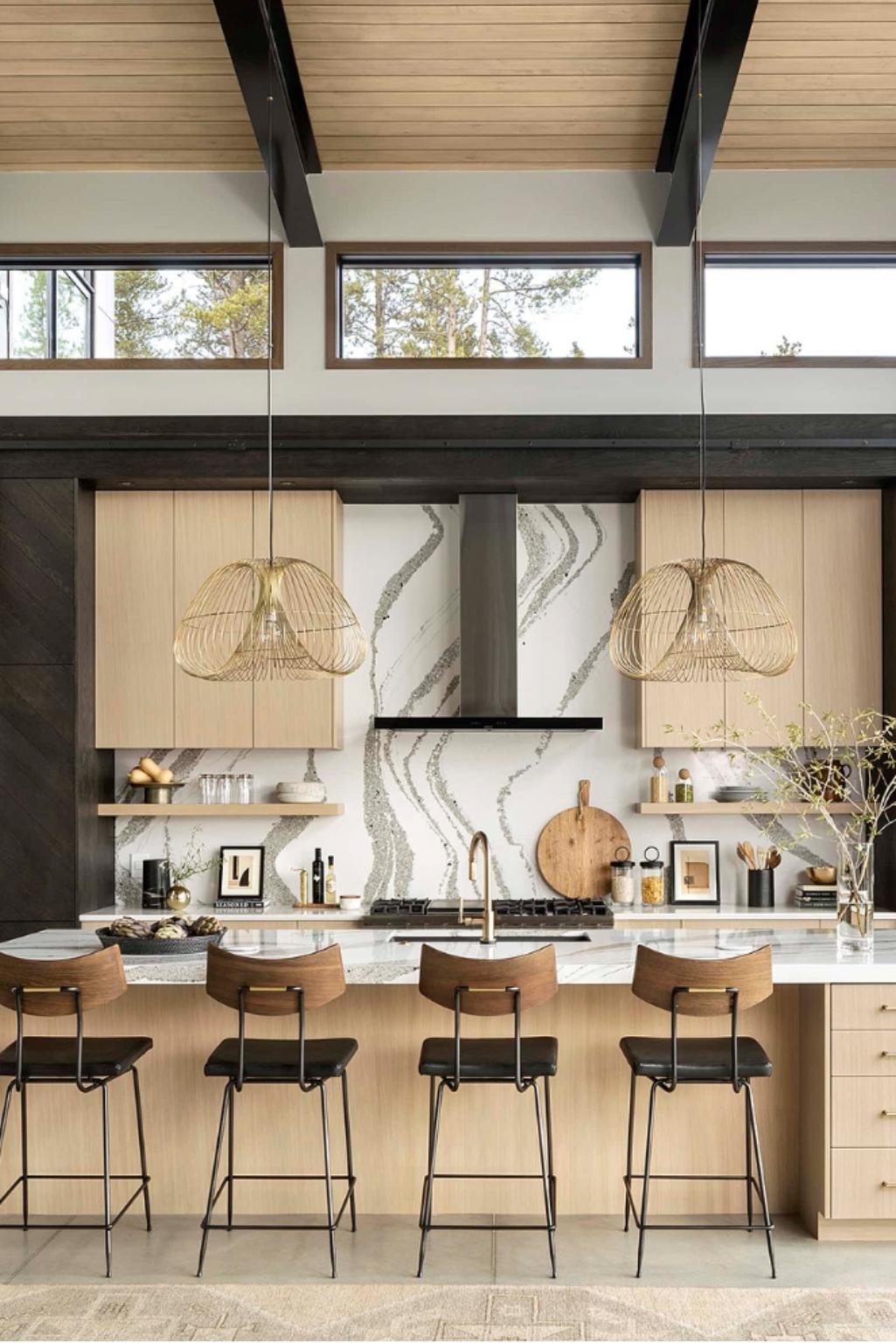 Modern kitchen showcasing white oak kitchen cabinets with natural grain and golden undertones, accented by black framing and statement lighting.