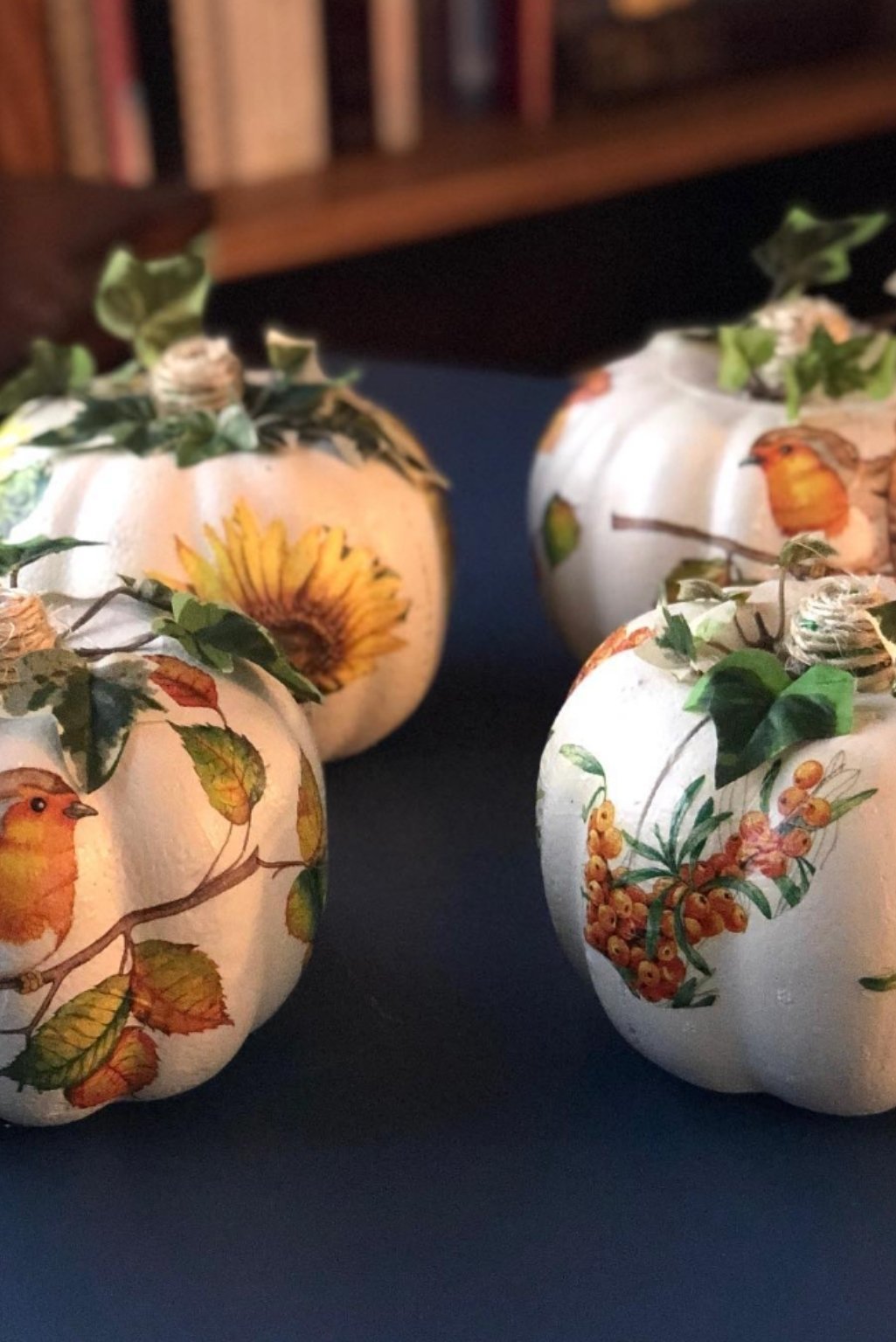 White pumpkins decorated with decoupage featuring sunflowers, birds, and autumn branches—handcrafted for a unique fall look.