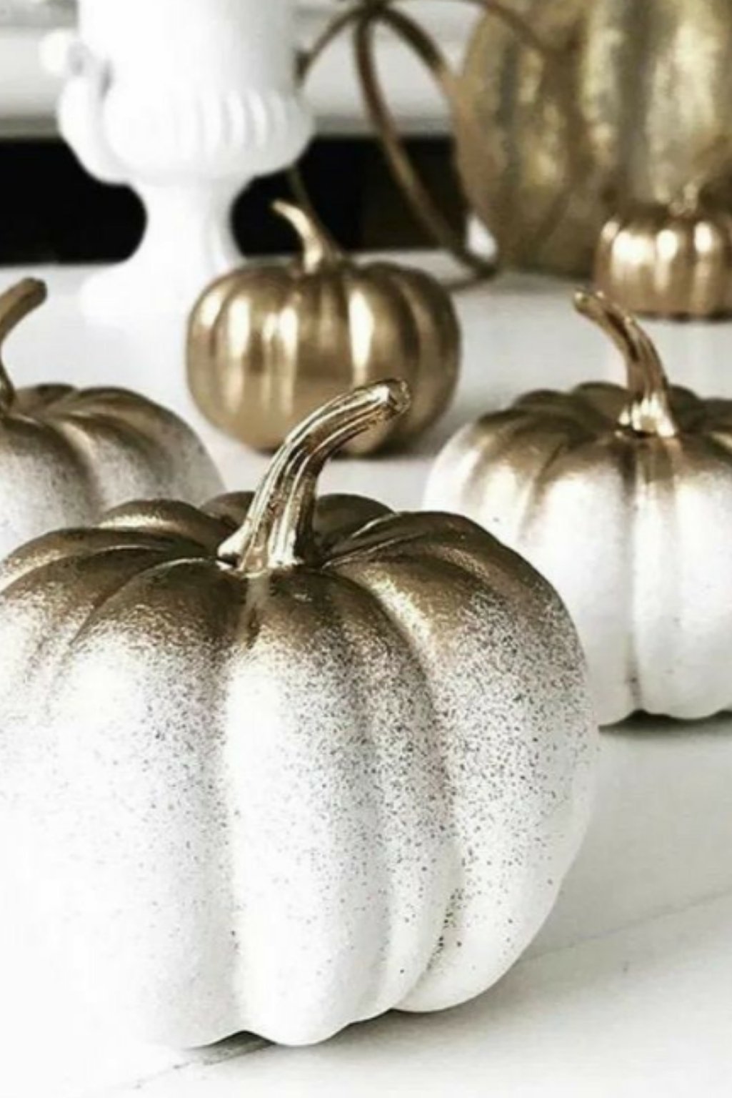 Metallic dipped white pumpkins used for glamorous fall decor styling.