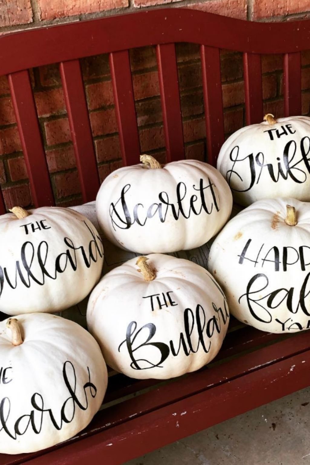 White pumpkins customized with modern calligraphy as personalized name placeholders.