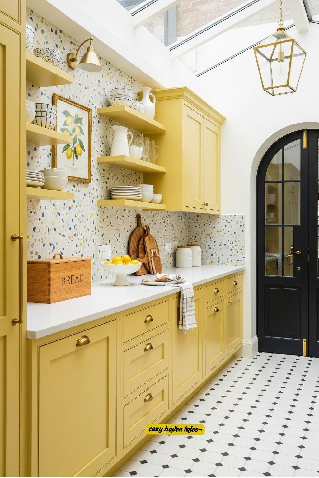Open shelving and terrazzo tiles with pastel yellow cabinetry