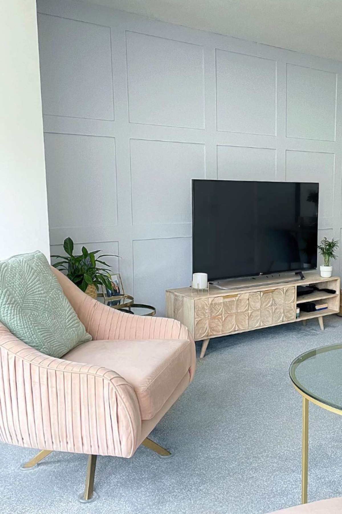 Minimalist blush seating with blue-gray panels and gold accents.