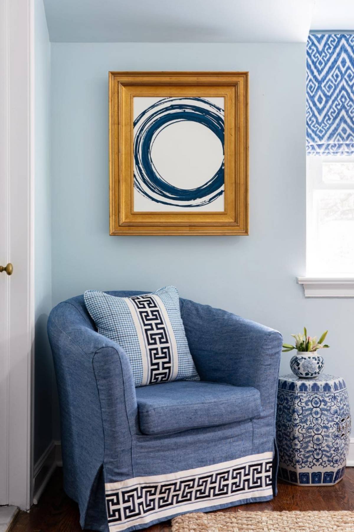 Indigo armchair and ceramics with light blue walls.