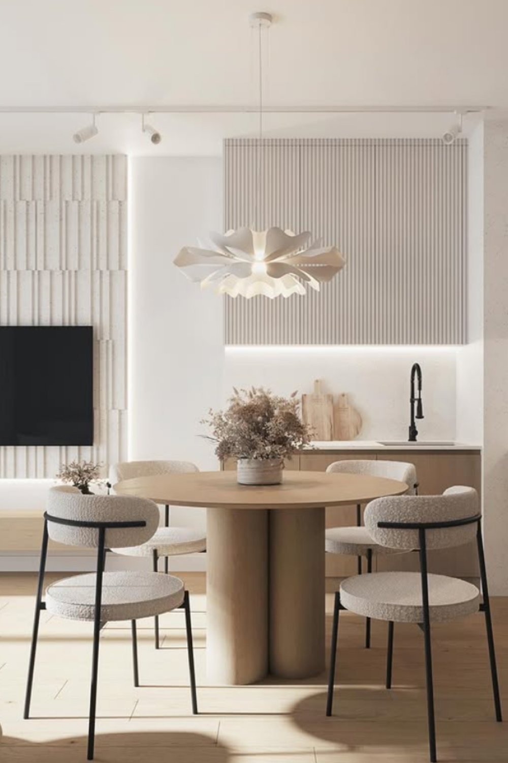 Contemporary design with round table, sleek chairs, and sculptural pendant.