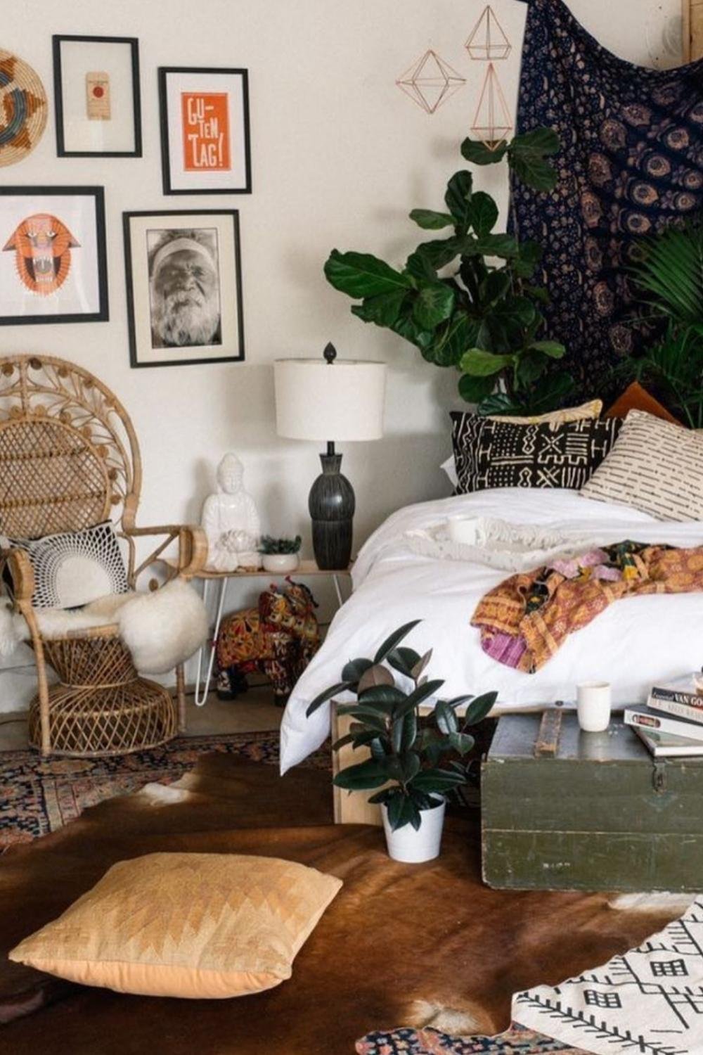 Boho accent wall with framed art, woven baskets, and eclectic bedroom styling.