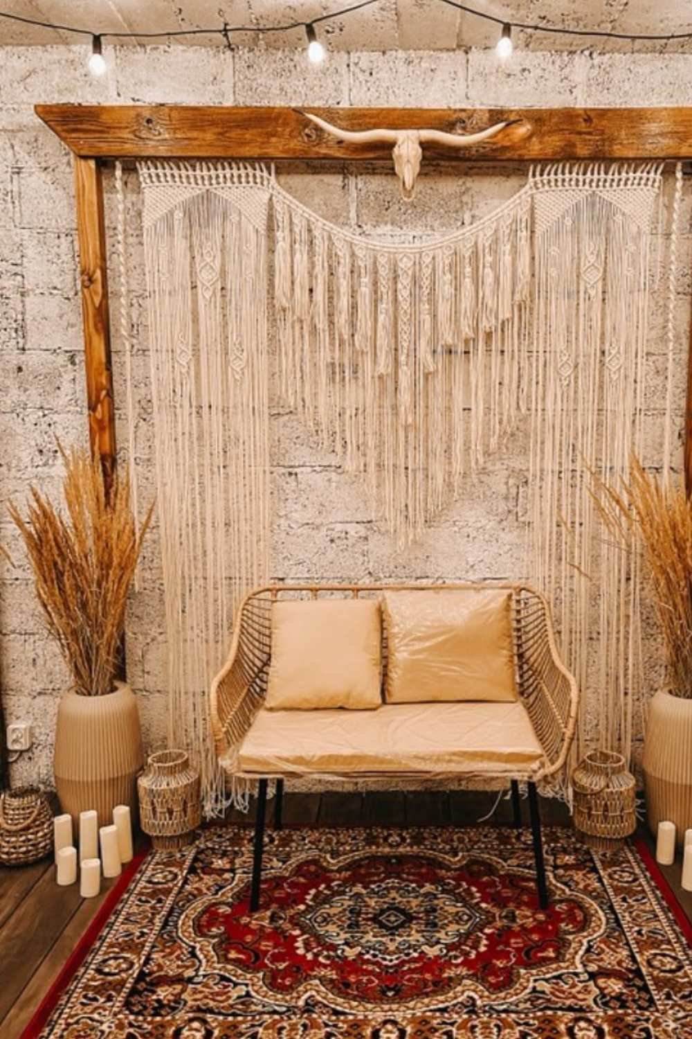Rustic boho wall with macramé backdrop, wooden frame, and dried floral accents.