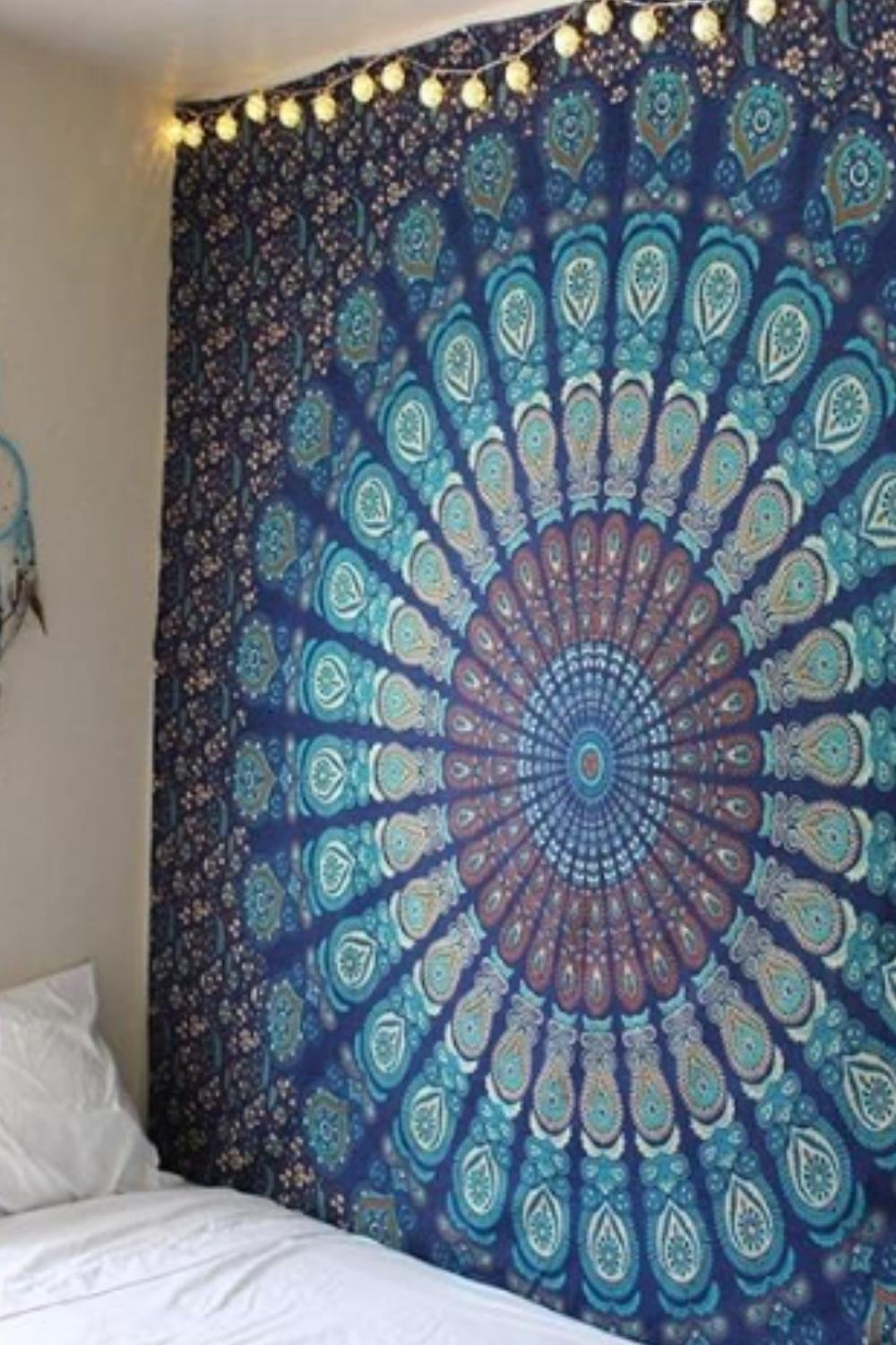 Boho wall with blue mandala tapestry and dreamy fairy lights.