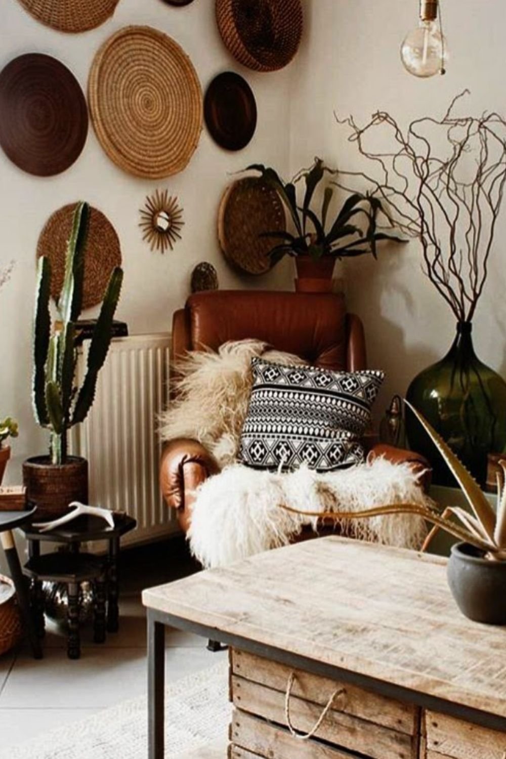 Boho wall styled with woven basket gallery, cozy chair, and indoor plants.