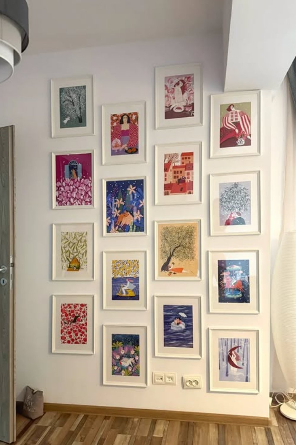 Symmetrical gallery wall with framed artwork in a neat grid layout.